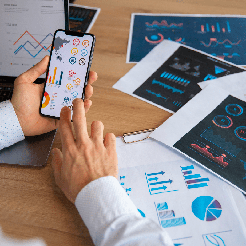 Office workers using finance graphs